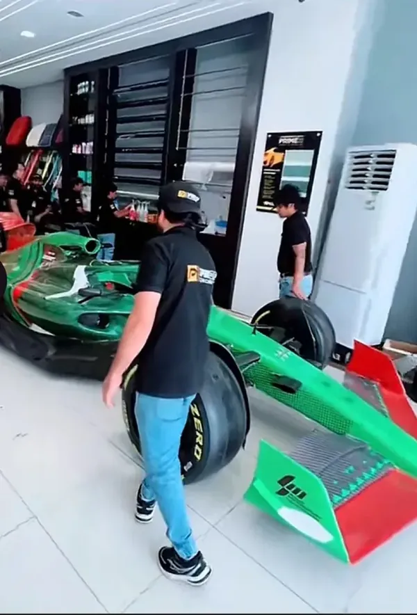 سيارة فورمولا داخل معرض PROF Car Care وفريق العمل بزي الشركة